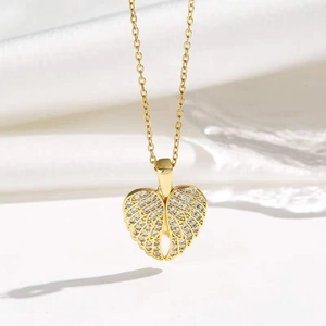 Elegant gold necklace featuring a heart-shaped angel wing pendant set with crystals