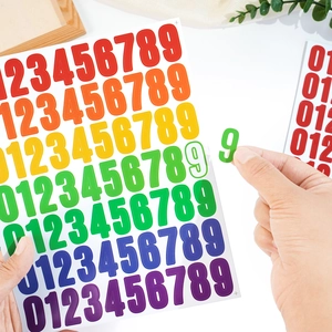 Close-up of peeling colorful 1-inch waterproof vinyl number stickers from 0 to 9