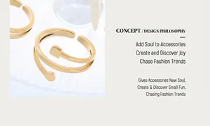 Detail of minimalist 18K gold plated steel ring with asymmetric open design on texture
