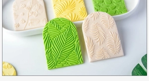 Detail of leaf pattern texture on floral fondant cookie stamps for cake decoration