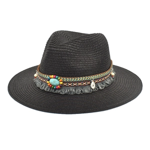 Detail of black straw fedora featuring bohemian band with turquoise beads and grey fringe