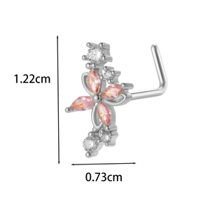 Macro view of silver cross nose stud with pink and white zircon crystals and L-shaped bar