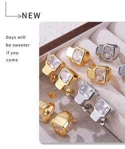 Detail of square-cut crystals on gold and silver stud earrings in a luxury jewelry box