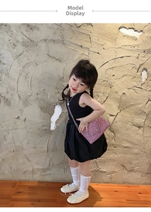 Girl in black puffy dress showing matching pink sequin rhinestone crossbody chain bag