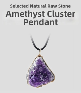 Macro shot of natural raw amethyst crystal cluster pendant with gold wire wrapping detail