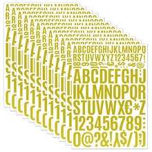 Detailed stack of gold vinyl letter and number stickers for scrapbooking and DIY gifts