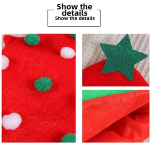 Detail of red Christmas hat with white and green plush balls and a green star patch