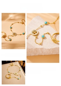 Detailed view of gold plated tree of life slave bracelet with turquoise bead accents
