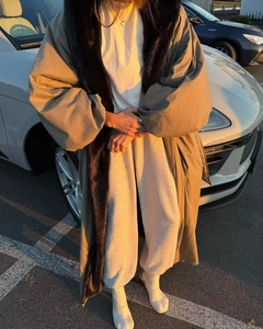 Parka kaki con collo di pelliccia marrone e polsini morbidi al tramonto all'aperto
