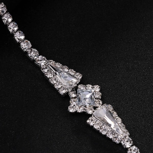 Elegant silver necklace with geometric diamond squares on a sleek black background
