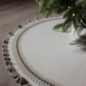 Knitted Christmas tree skirt in cream with brown geometric patterns and tassel fringe edge