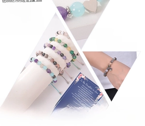 Detail of natural gemstone beaded bracelets with metal heart charms for gift sets