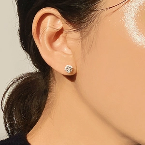 Elegance 925 silver stud earrings with four-prong zircon stones on female ear