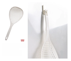 Detail of white kitchen skimmer with ergonomic long handle and hanging hole design