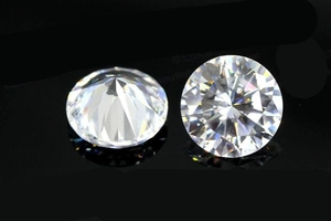 Macro shot of two D-color round brilliant cut moissanite stones with sparkling fire