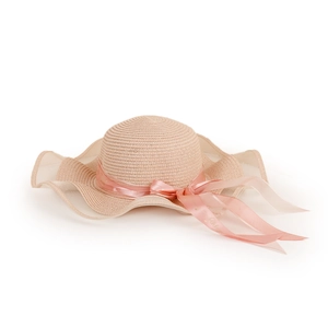 Detail of wide wavy straw hat brim with sheer mesh trim and elegant pink ribbon bow