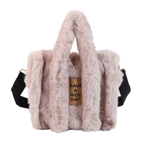 Detail of plush tote bag in dusty pink with faux rabbit fur texture and nylon straps