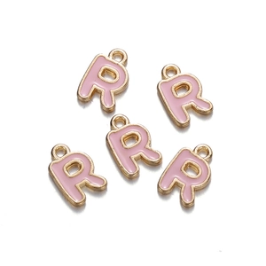 Detailed view of pink enamel alphabet R charms with gold metal edges for DIY jewelry