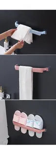 Detail of self-adhesive wall mounted towel rack and slipper storage in blue and pink