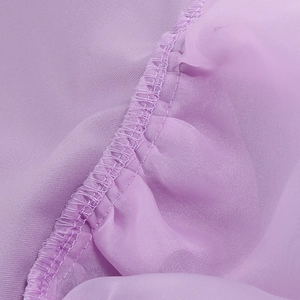 Macro shot of light purple chiffon fabric with precise pleated stitching details