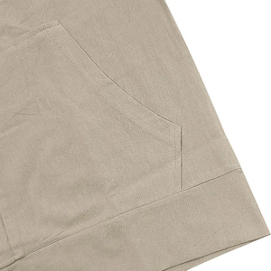 Detail view of khaki linen shirt featuring large patch pocket and double-stitch sewing