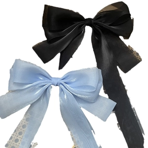 Oversized ribbon bow hair clips in black and blue organza with long flowing tassels