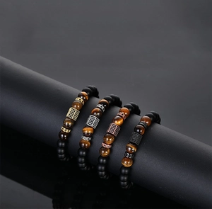 Detail of tiger eye and matte black bead bracelets with micro-inlaid zircon hexagonal beads