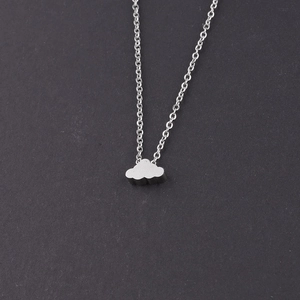 Macro view of mirror-polished silver cloud pendant and delicate chain necklace
