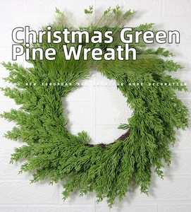 Close-up of artificial pine needle wreath with natural vine base for front door decor