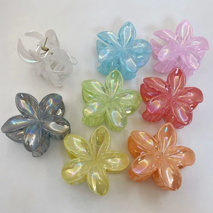 Macro view of transparent floral hair claws in eight assorted iridescent colors