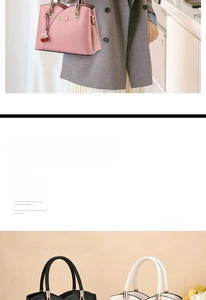 Detailed view of elegant trapezoid handbag with cherry charm and leather texture