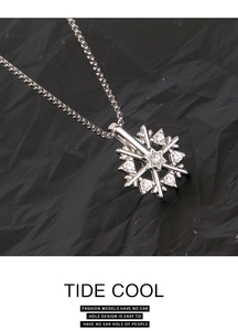 Macro shot of rotatable snowflake pendant necklace with sparkling zircon stones