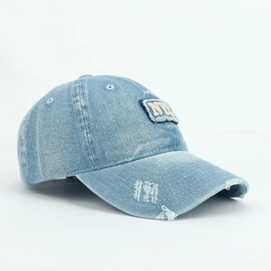 Close-up of light blue washed denim baseball cap with 3D NYC embroidery and distressed details