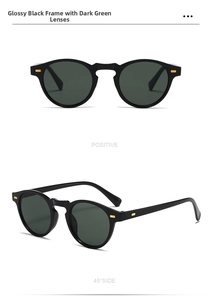 Détail de lunettes de soleil rondes rétro avec monture noire et verres vert foncé