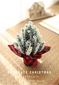 Close-up of 13cm mini Christmas tree with snow effect and red black checkered base