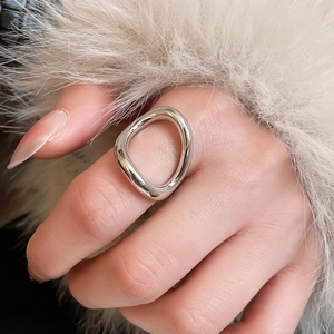Macro shot of a silver liquid metal ring with a polished geometric irregular design