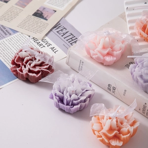 Floral carnation scented candles with elegant white ribbon bows in multiple colors