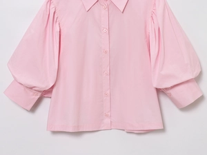 Detail shot of light pink long sleeve poplin shirt with soft texture and puff sleeves