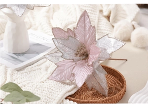 Detail of pink and silver artificial poinsettia with gold glitter edges for Christmas decor