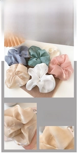 Macro shot of assorted colorful oversized satin scrunchies with smooth silky texture