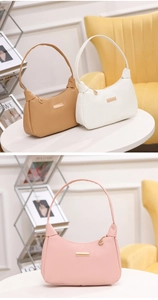 Detail of elegant pebble grain leather shoulder bags in brown, white and pink colors