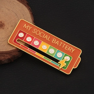 Detailed macro shot of the sliding social battery enamel pin on black leather