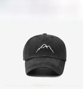 Front view of washed dark grey cotton baseball cap with white mountain peak embroidery