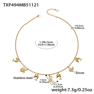 Detail view of 18k gold plated stainless steel ocean charm necklace with zircon pendants