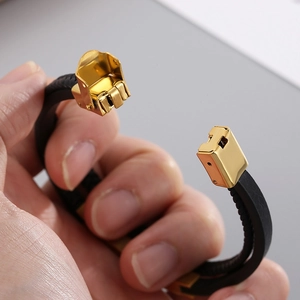 Men's multi-layer black leather bracelet featuring a golden stainless steel mechanical clasp
