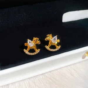 Gold plated rocking horse stud earrings with teardrop zircon and pavé crystals