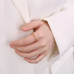 Detail of elegant gold titanium ring with colorful zircon crystals on a model hand
