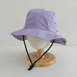 Detail of lavender quick-dry sun hat showing breathable metal eyelets and adjustable chin strap