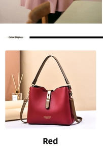 Detail of red leather bucket bag with gold metal lock and shoulder strap