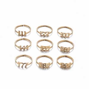 Detail view of nine gold stainless steel rings featuring 111-999 angel number designs